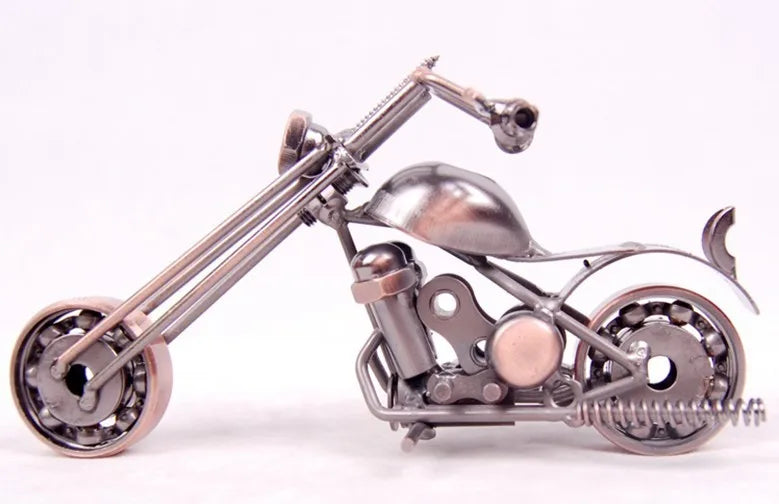 A handcrafted metal motorcycle model with chrome components and a vintage aesthetic.