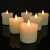 A row of glowing white tea lights in glass holders on a dark reflective surface.