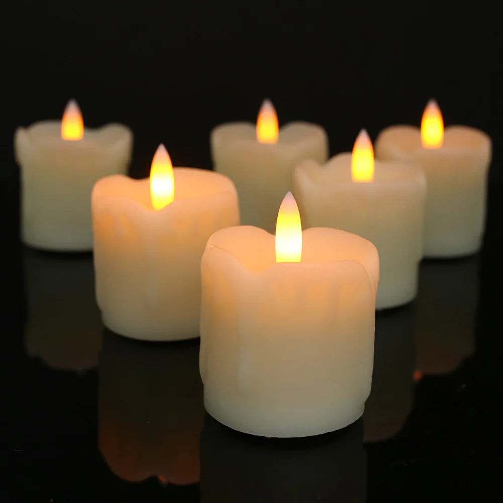 A row of glowing white tea lights in glass holders on a dark reflective surface.