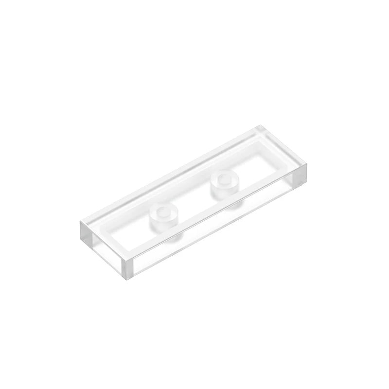 A clear rectangular tile with three smooth building bricks inside.