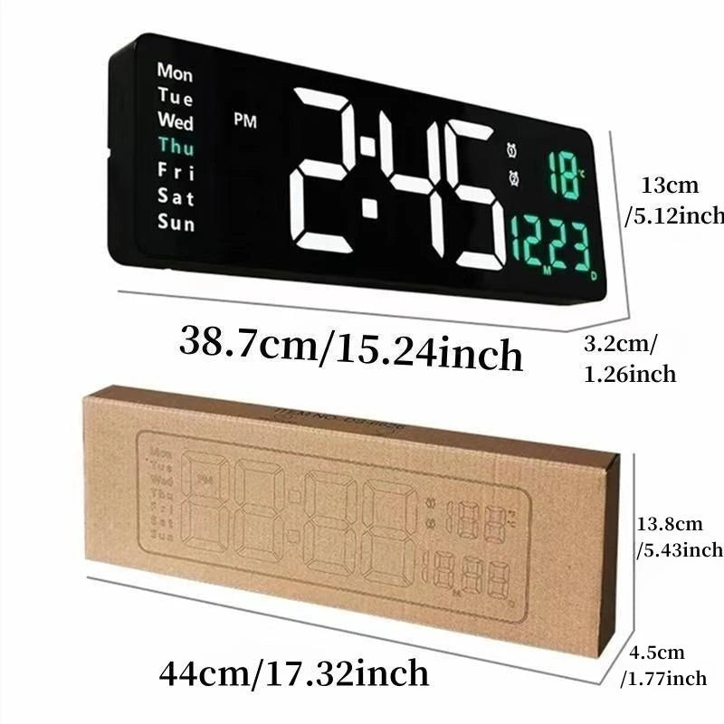 A black digital wall clock displaying time, temperature, and date, shown next to its cardboard packaging.