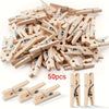 A pile of 50 wooden mini clothespins in natural wood color, showing various sizes and styles.