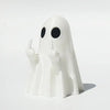 A white glow-in-the-dark ghost figurine with a playful pointing pose.