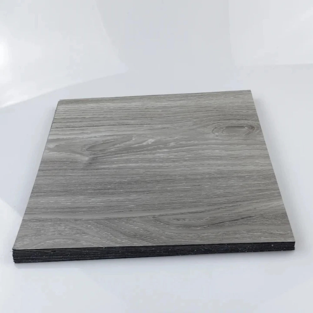 A rectangular piece of dark gray wood grain laminate or sticker material.