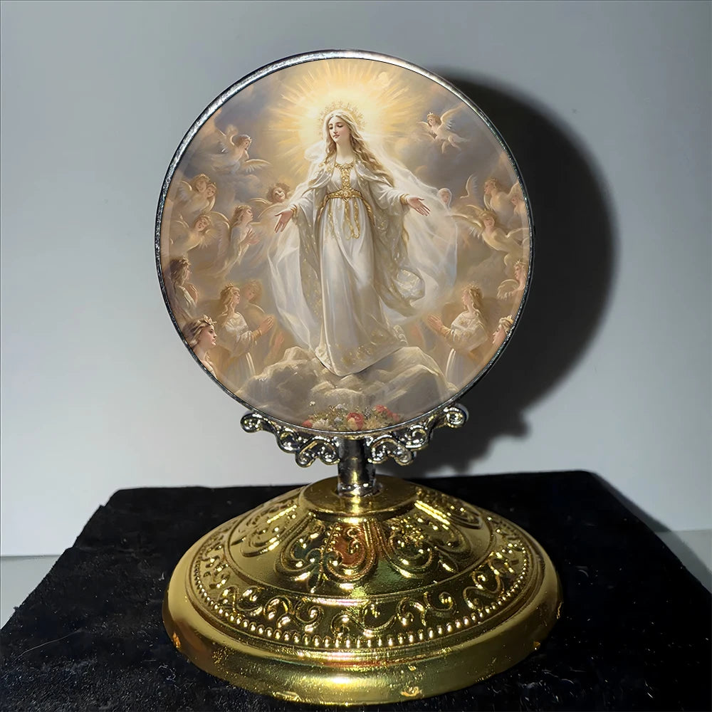 A vintage glass ornament featuring a depiction of the Virgin Mary surrounded by angels on a gold base.