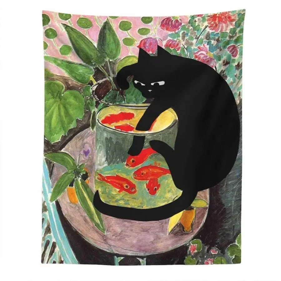 A black cat sits on a table next to a glass of water containing several goldfish, set against a floral tapestry background.