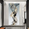 Abstract wall art featuring swirling black and gold ribbons on a light gray background.