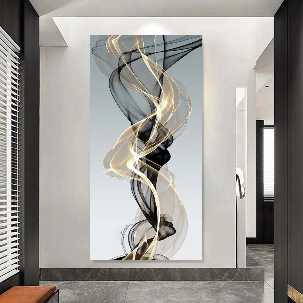 Abstract wall art featuring swirling black and gold ribbons on a light gray background.