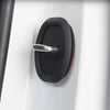 A close-up of a black silicone door lock protector with a silver handle mounted on a white surface.