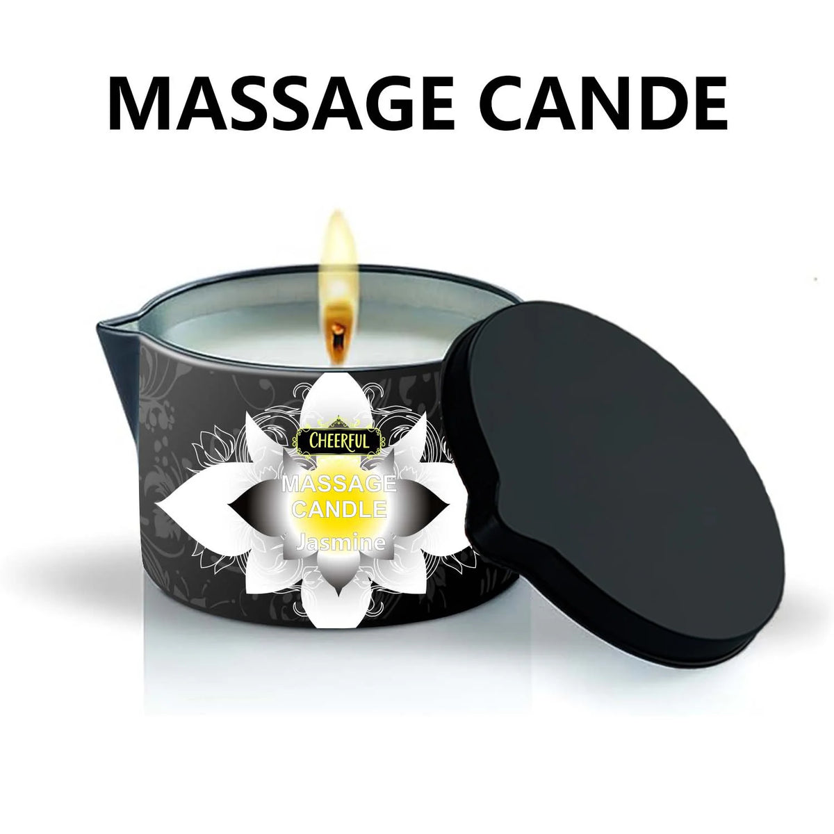 A black massage candle in a glass holder with a lit wick and a separate black lid.