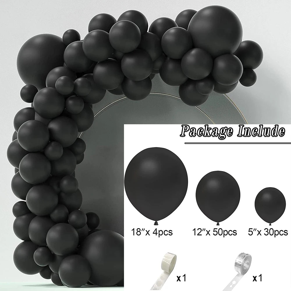 A black balloon garland arch made of round balloons, shown in a close-up with accessories.