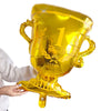 A golden foil soccer trophy balloon with the number 1 and winner text being held by a hand.