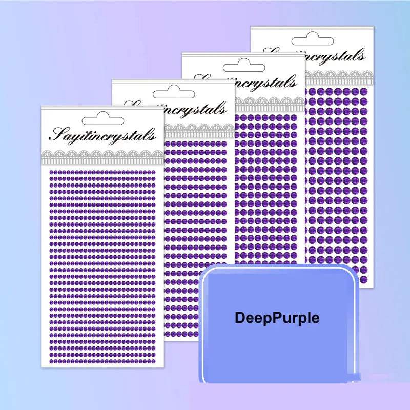 A collection of purple and silver self-adhesive rhinestone embellishments in various sizes and shapes.