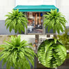 Two large artificial Boston ferns displayed in a glass cabinet with a teal roof.