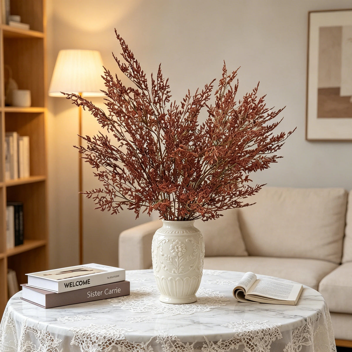 A vase filled with artificial silk lover grass on a white table setting