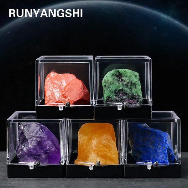 A display of various natural crystal rough stone specimens including pink, green, purple, orange, and blue stones.