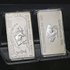 Two silver bullion bar replicas, one American and one German, are displayed in protective plastic packaging.