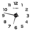 A black and silver giant acrylic wall clock showing the time as 12 o'clock.