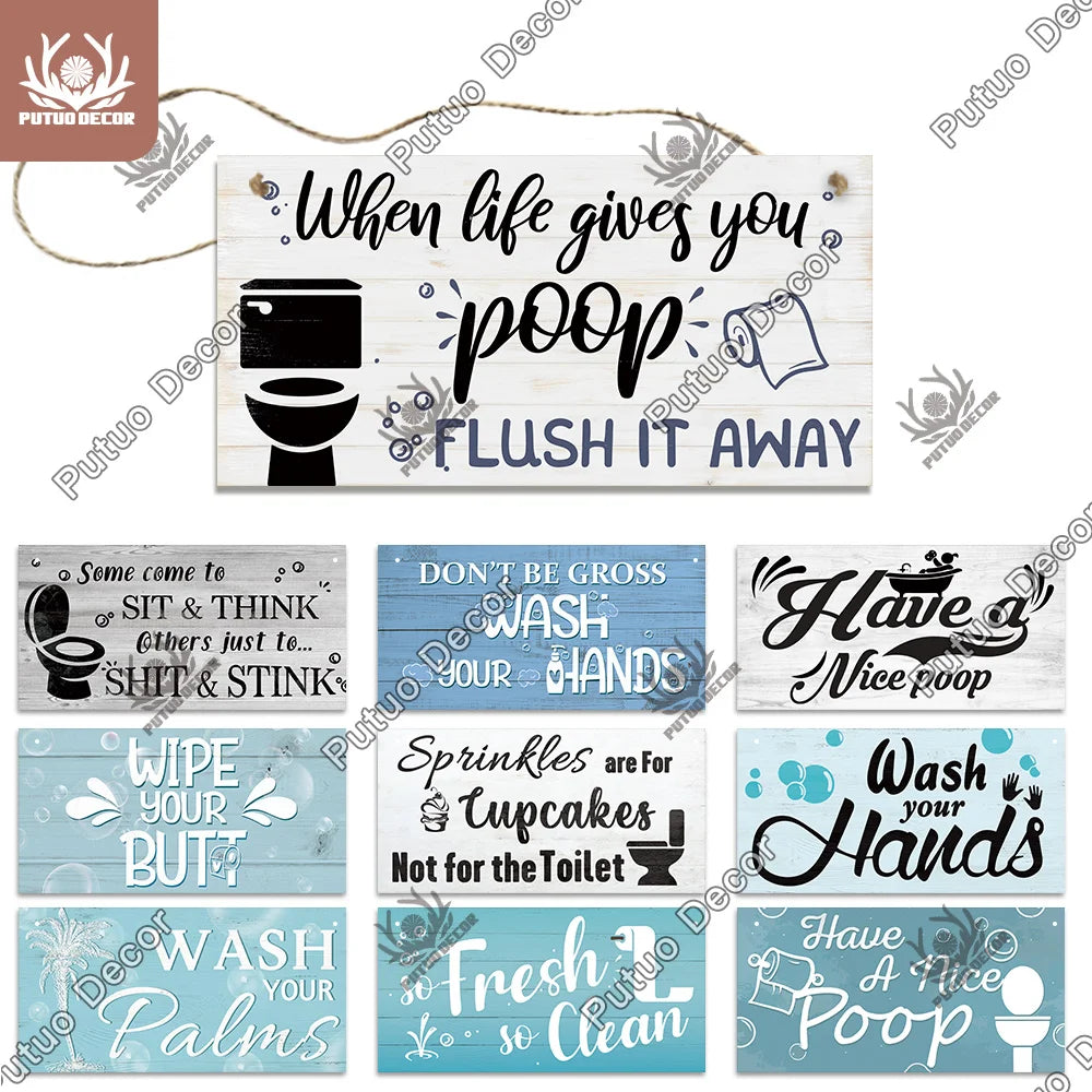 A set of rustic wooden signs with humorous phrases about using the toilet and washing hands