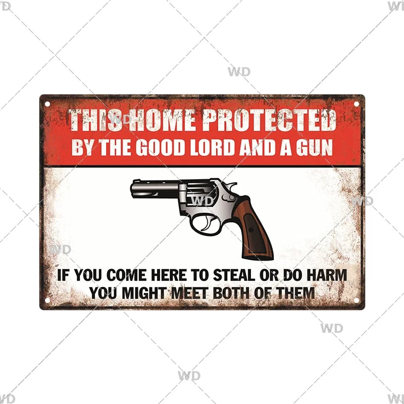 A vintage metal warning sign with text that reads This Home Protected by the Good Lord and a Gun and an image of a handgun.