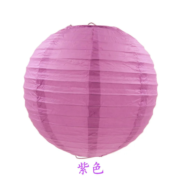 A round pink paper lantern with vertical folds.