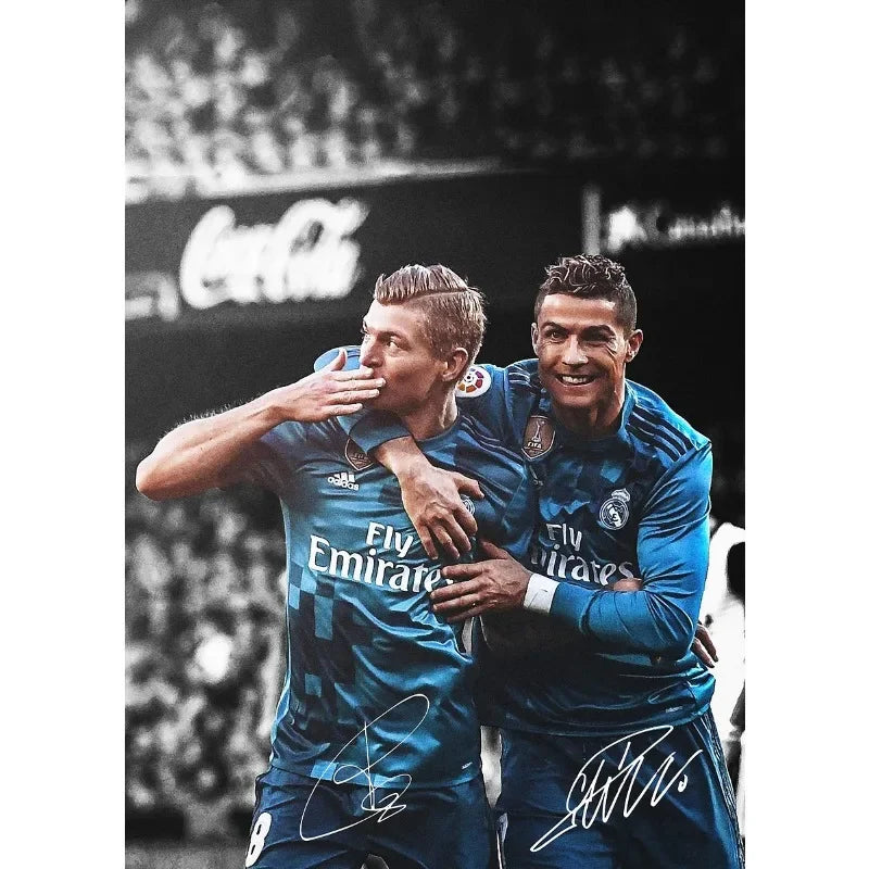 A black and white portrait of two male soccer players in blue jerseys celebrating on a field.