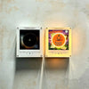 A pair of magnetic vinyl record night lights featuring Halloween themed designs and LED glow on a white wall.