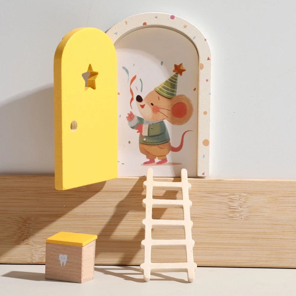 A wooden fairy elf door miniature decoration next to a small tooth box and a wooden ladder.