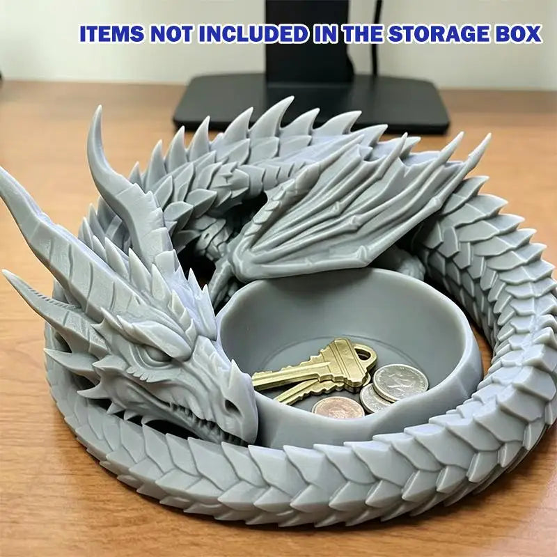 A gray dragon design decorative tray for jewelry and small items is shown, with a key resting inside.