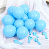 A collection of light blue latex balloons scattered on white sheer fabric.