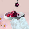 A silicone raspberry mousse mold with six cavities is shown next to fresh raspberries and a dripping fruit dessert.