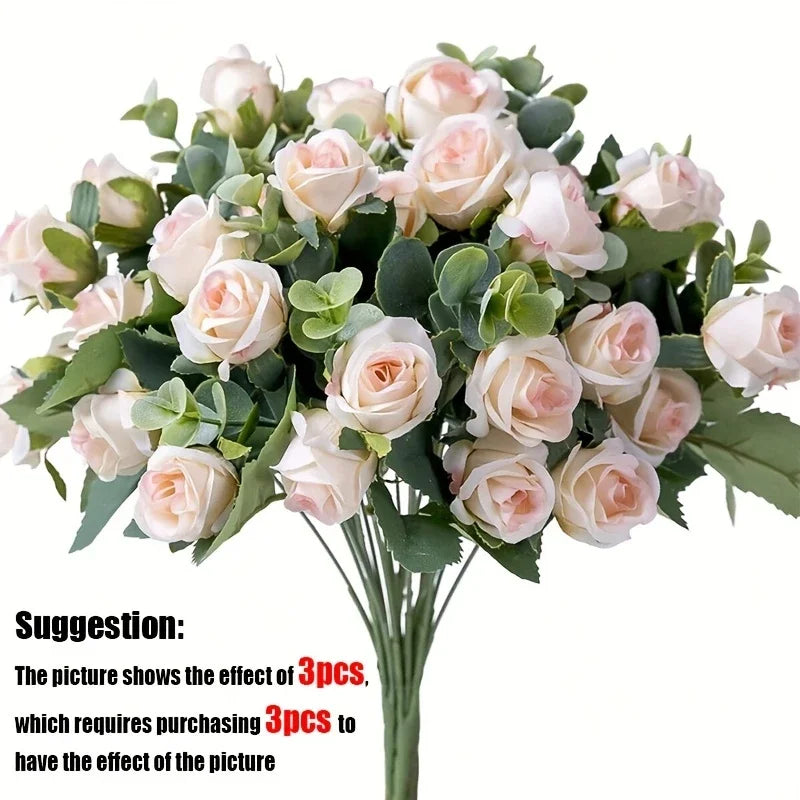 A bouquet of light pink silk roses and green eucalyptus leaves for wedding or home decor