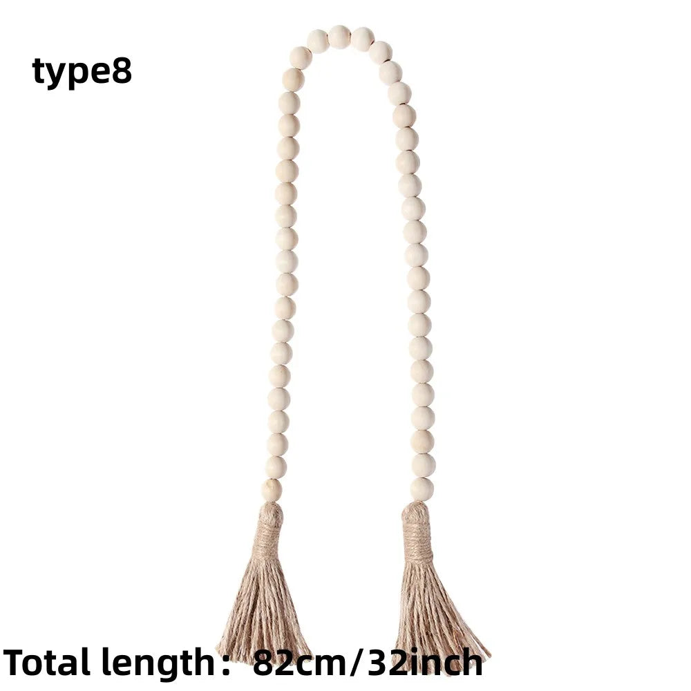 Boho farmhouse tassel bead wall hanging with a long string of light beige wooden beads and fringed tassels