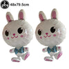Two white bunny-shaped foil balloons with pink ears and blue accents