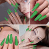 Close-up of hands displaying various shades of green glitter nail polish for DIY crafts and nail art.