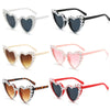 A set of pearl-embellished heart-shaped sunglasses in various colors and styles.