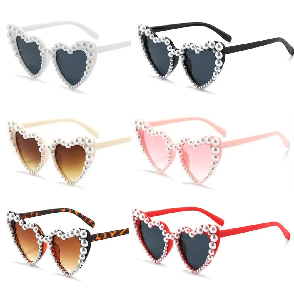 A set of pearl-embellished heart-shaped sunglasses in various colors and styles.