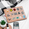 A laptop featuring various funny decals for laptops, bottles, and car surfaces on a wooden background.