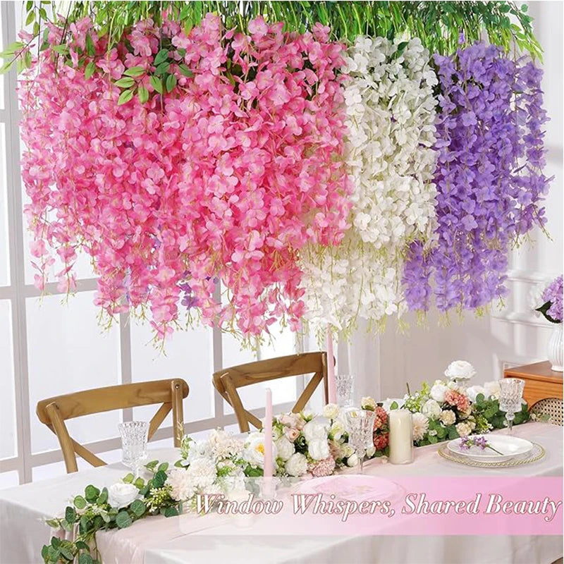 Artificial wisteria hanging flower garland in pink and purple shades decorating a table setting