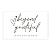 A white card with handwritten text that says beyond grateful and thank you so much