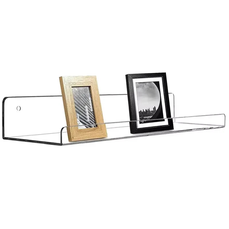 A clear acrylic floating storage rack set displaying two framed photos, one wooden and one black.