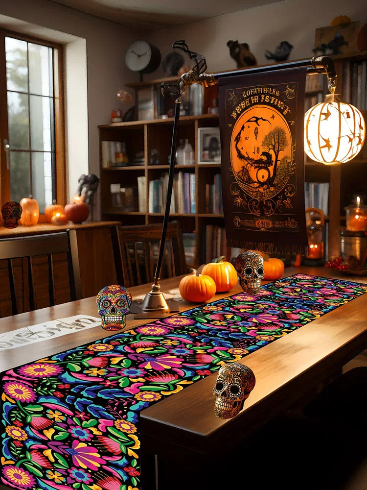 A colorful linen table runner with floral patterns is displayed on a wooden table in a home setting.