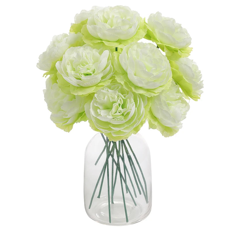 A bouquet of six artificial light green peony flowers arranged in a clear glass vase.