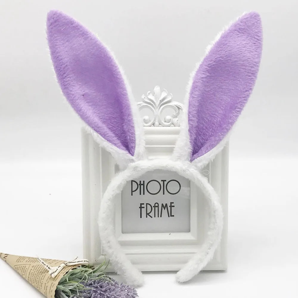 A pair of purple bunny ear headbands displayed in a white photo frame.