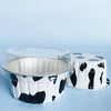 A clear reusable aluminum foil dessert ramekin with a lid and a white and black spotted version.