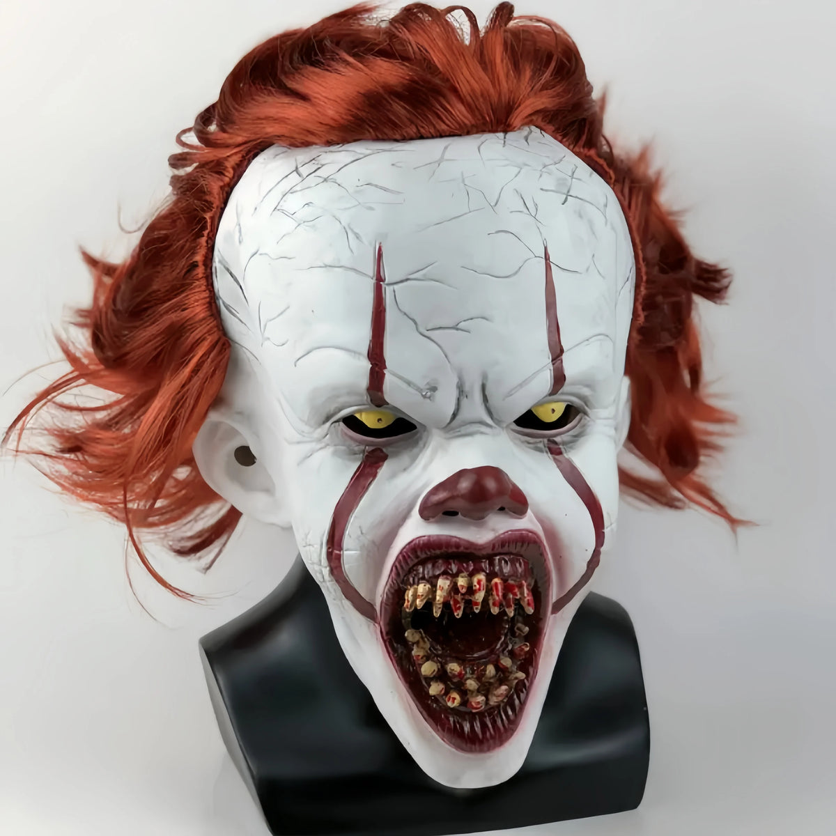 A realistic cute alien full-face latex mask with white skin, red hair, and an open mouth showing teeth.