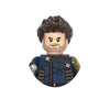 A building block figure of a male character with dark curly hair and a beard wearing a blue jacket.