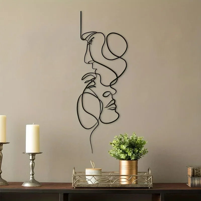 Minimalist abstract face metal wall art featuring a line drawing of a woman's profile on a beige wall.