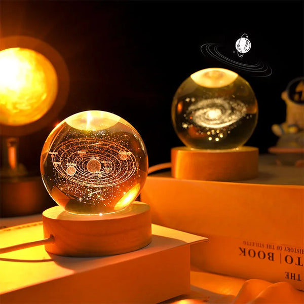 A glowing crystal ball night light rests on a wooden base, illuminated against a dark background.