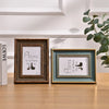 Two wooden photo frames display the text Home Is Where The Is with silhouette icons on a light background.